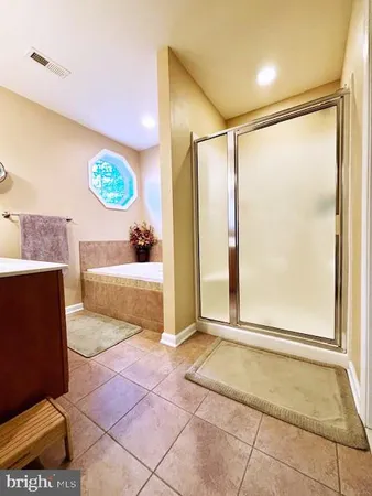 a view of a bathroom with a tub and a shower