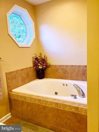 a bath tub sitting next to a blue wall