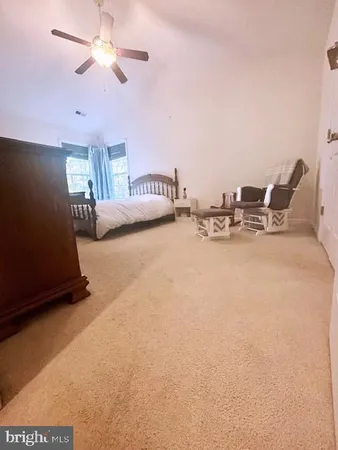 a view of living room with furniture and a ceiling fan