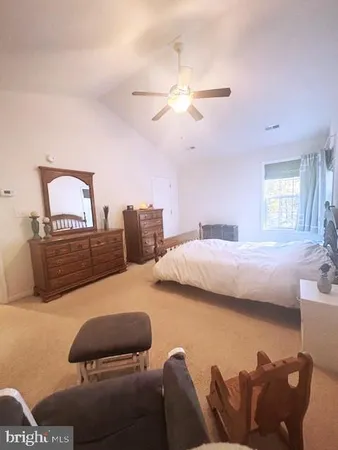 a bedroom with furniture and a chandelier