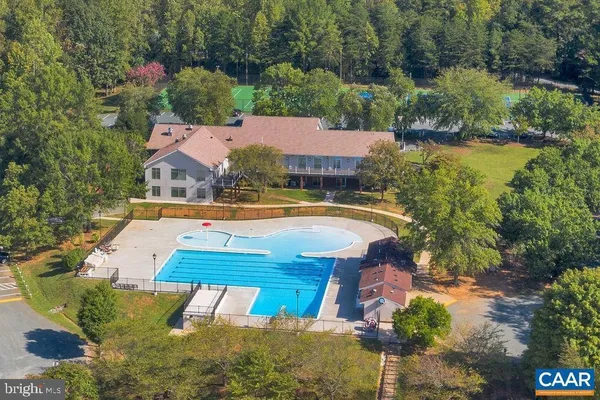an aerial view of a house with swimming pool outdoor seating and yard