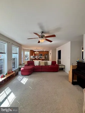 a living room with furniture and a pool table