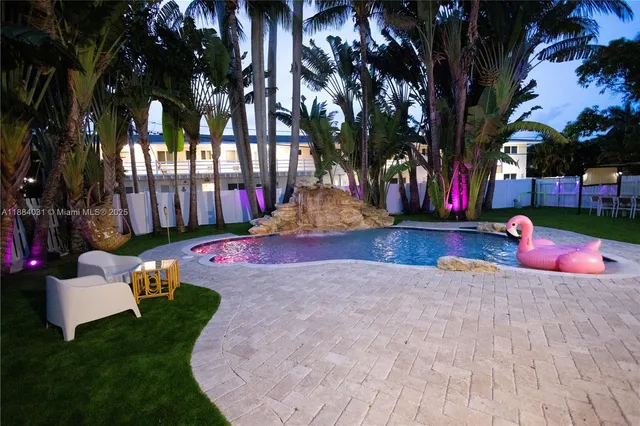 a view of yard with swimming pool and sitting area