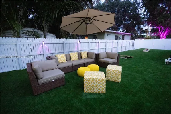 a backyard of a house with table and chairs