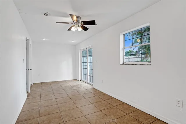 a view of a house with backyard and parking