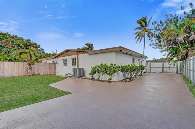 a view of a backyard with a garden and entertaining space