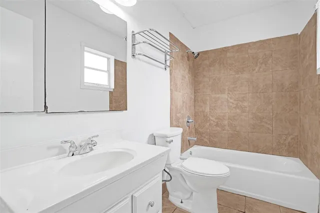 a view of backyard with potted plants and a tree