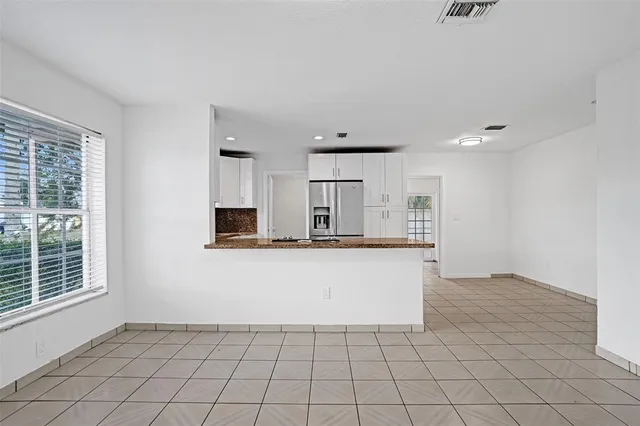 a view of kitchen with granite countertop cabinets