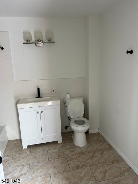 1210 Roselle Street Linden, NJ 07036 - Photo 12 of 15 a white toilet sitting next to a bathroom sink