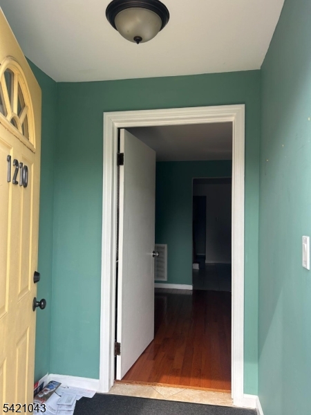 1210 Roselle Street Linden, NJ 07036 - Photo 2 of 15 a view of hallway with wooden floor