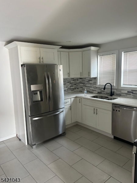 1210 Roselle Street Linden, NJ 07036 - Photo 5 of 15 a kitchen with a refrigerator sink and cabinets