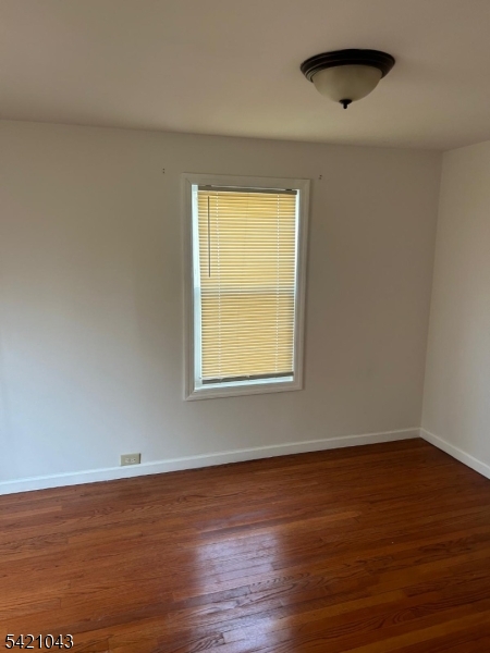 1210 Roselle Street Linden, NJ 07036 - Photo 9 of 15 a view of an empty room with wooden floor and a window