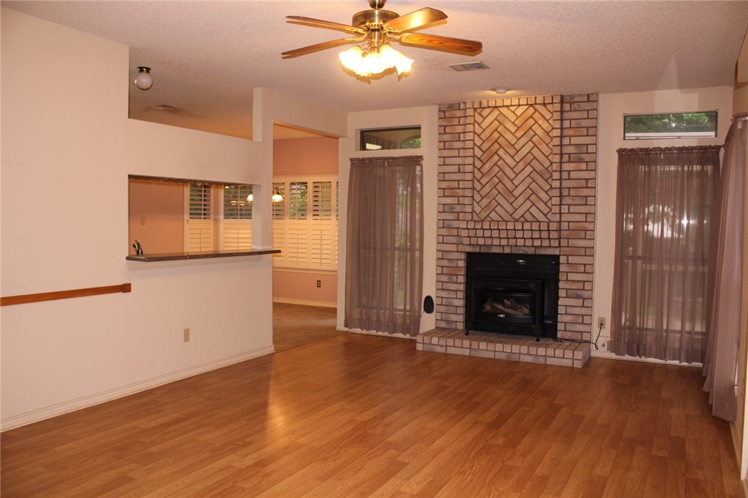 2141 Surrender Avenue Austin, TX 78728 - Photo 11 of 38 a view of an empty room with a fireplace and a window