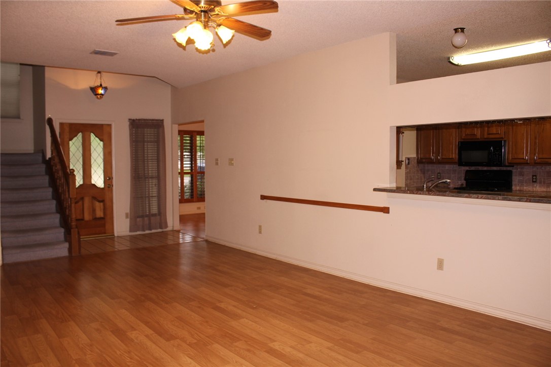 2141 Surrender Avenue Austin, TX 78728 - Photo 12 of 38 a view of a livingroom with wooden floor and a ceiling fan