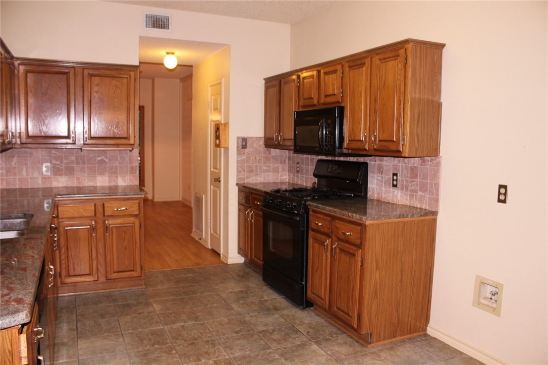 2141 Surrender Avenue Austin, TX 78728 - Photo 16 of 38 a kitchen with stainless steel appliances granite countertop a refrigerator and a stove top oven