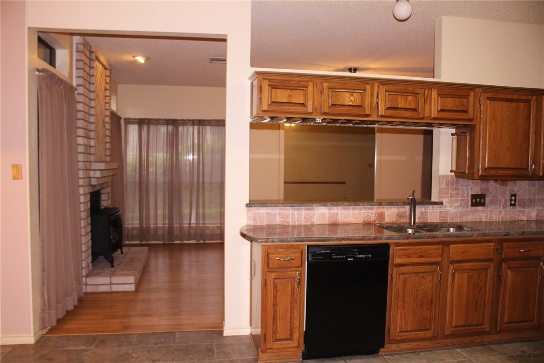 2141 Surrender Avenue Austin, TX 78728 - Photo 17 of 38 a kitchen with a refrigerator and a sink
