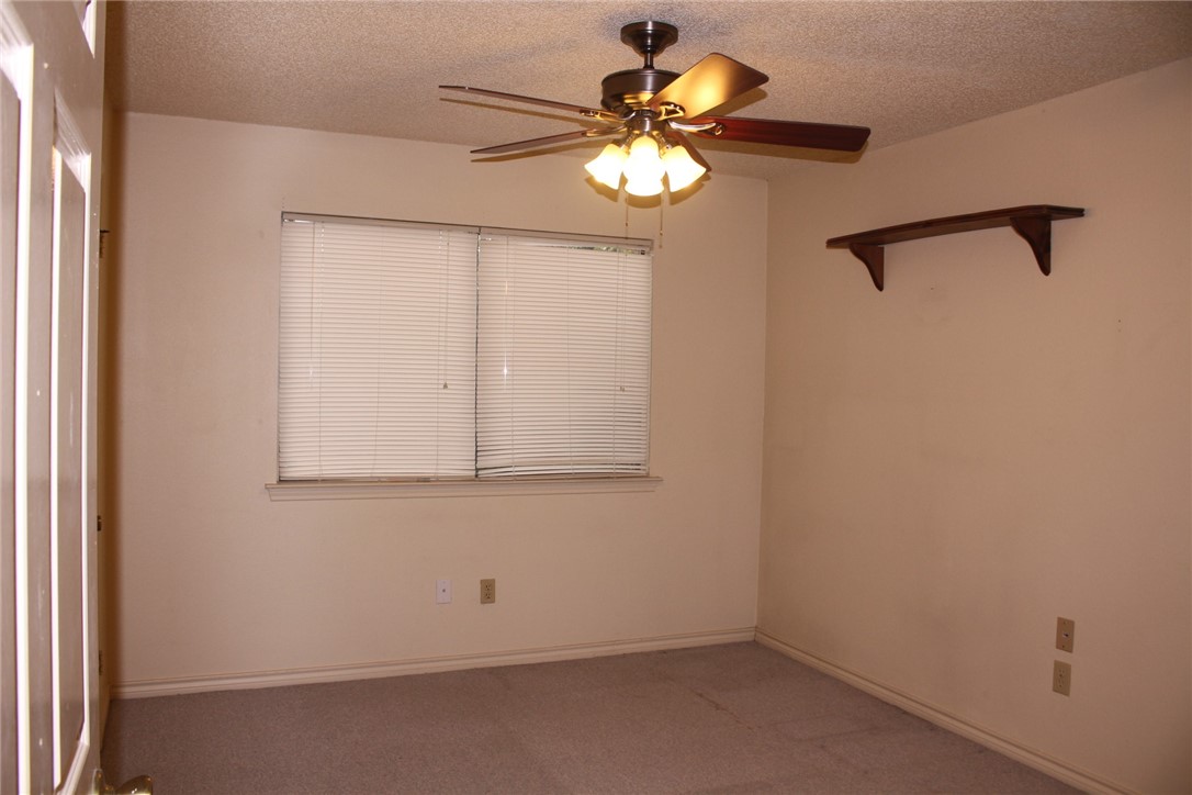 2141 Surrender Avenue Austin, TX 78728 - Photo 22 of 38 an empty room with a chandelier fan