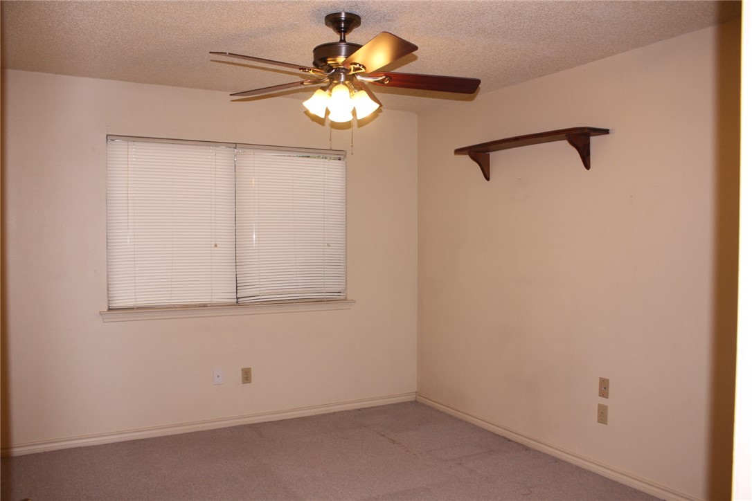 2141 Surrender Avenue Austin, TX 78728 - Photo 23 of 38 an empty room with a chandelier fan
