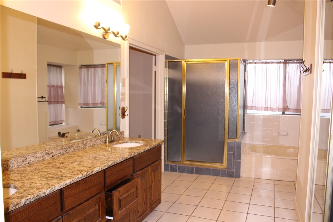 2141 Surrender Avenue Austin, TX 78728 - Photo 25 of 38 a bathroom with a granite countertop sink and a mirror