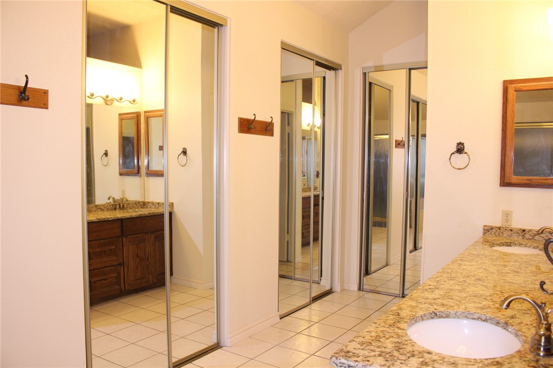 2141 Surrender Avenue Austin, TX 78728 - Photo 29 of 38 a bathroom with a granite countertop sink and a mirror