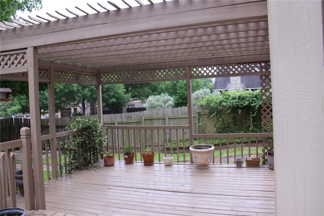 2141 Surrender Avenue Austin, TX 78728 - Photo 34 of 38 a view of a patio with table and chairs potted plants with wooden floor and fence