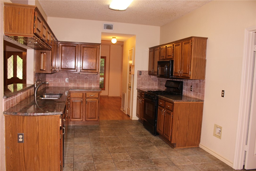2141 Surrender Avenue Austin, TX 78728 - Photo 5 of 38 a kitchen with stainless steel appliances granite countertop a refrigerator stove and sink