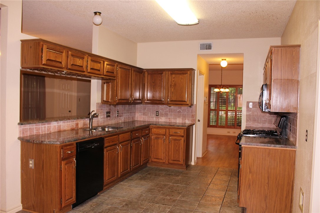 2141 Surrender Avenue Austin, TX 78728 - Photo 6 of 38 a kitchen with granite countertop a sink stainless steel appliances and cabinets