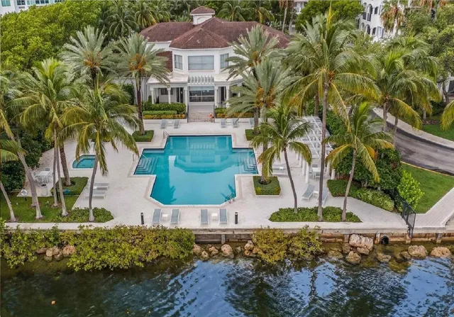 a living room with furniture a chandelier and a large window