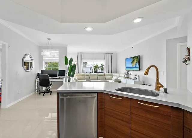 a kitchen with counter top space and living room