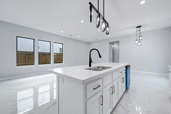 a view of a kitchen with a sink and chandelier
