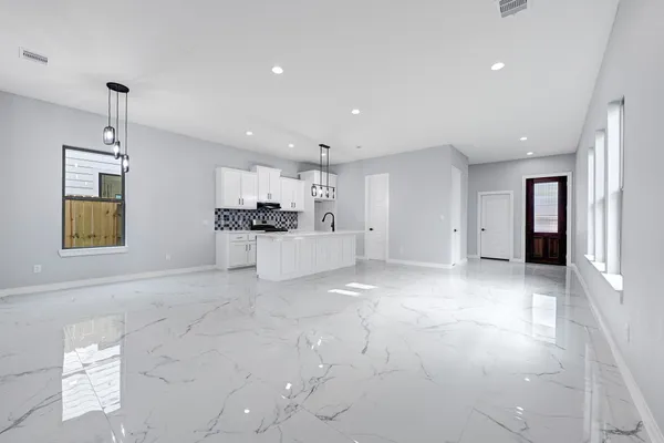 a view of a kitchen with a sink and cabinets