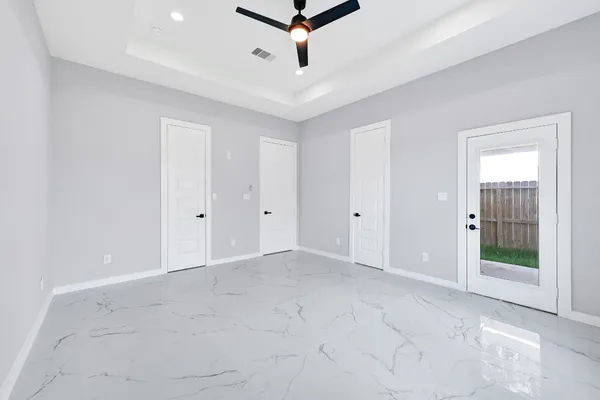 a view of a room with a ceiling fan