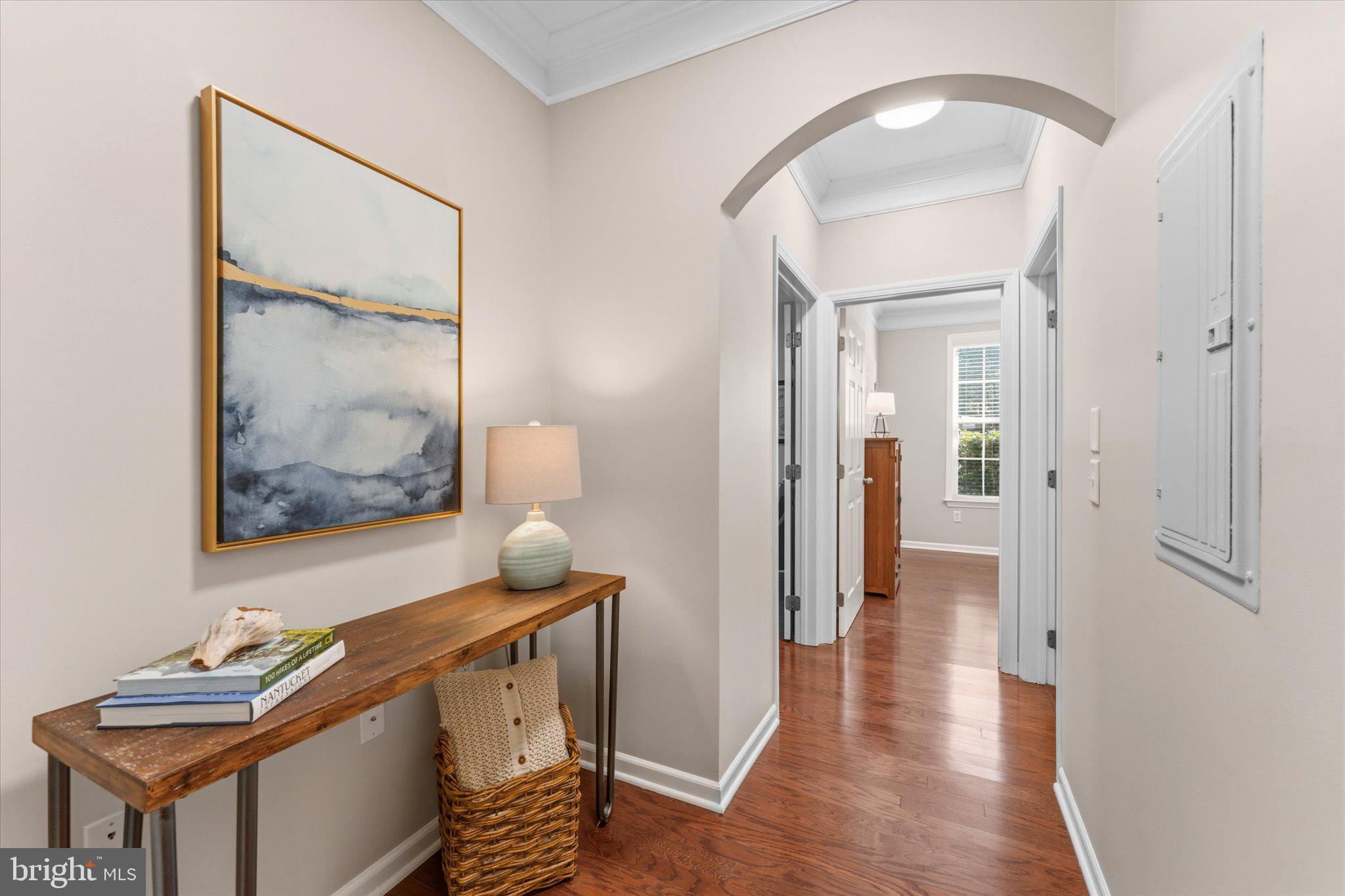 503 Sunset View Terrace Southeast, Unit 101 Leesburg, VA 20175 - Photo 21 of 39 Inviting hallway with serene artwork.