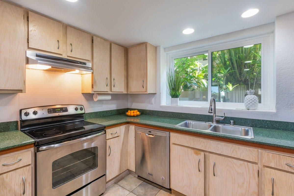 1661 Pee Road, Unit IIA101 Koloa, HI 96756 - Photo 12 of 28 a kitchen with granite countertop a sink stove and cabinets