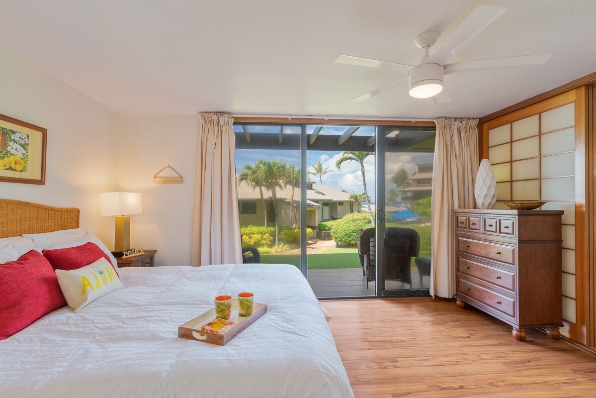 1661 Pee Road, Unit IIA101 Koloa, HI 96756 - Photo 14 of 28 a bedroom with a bed and large window