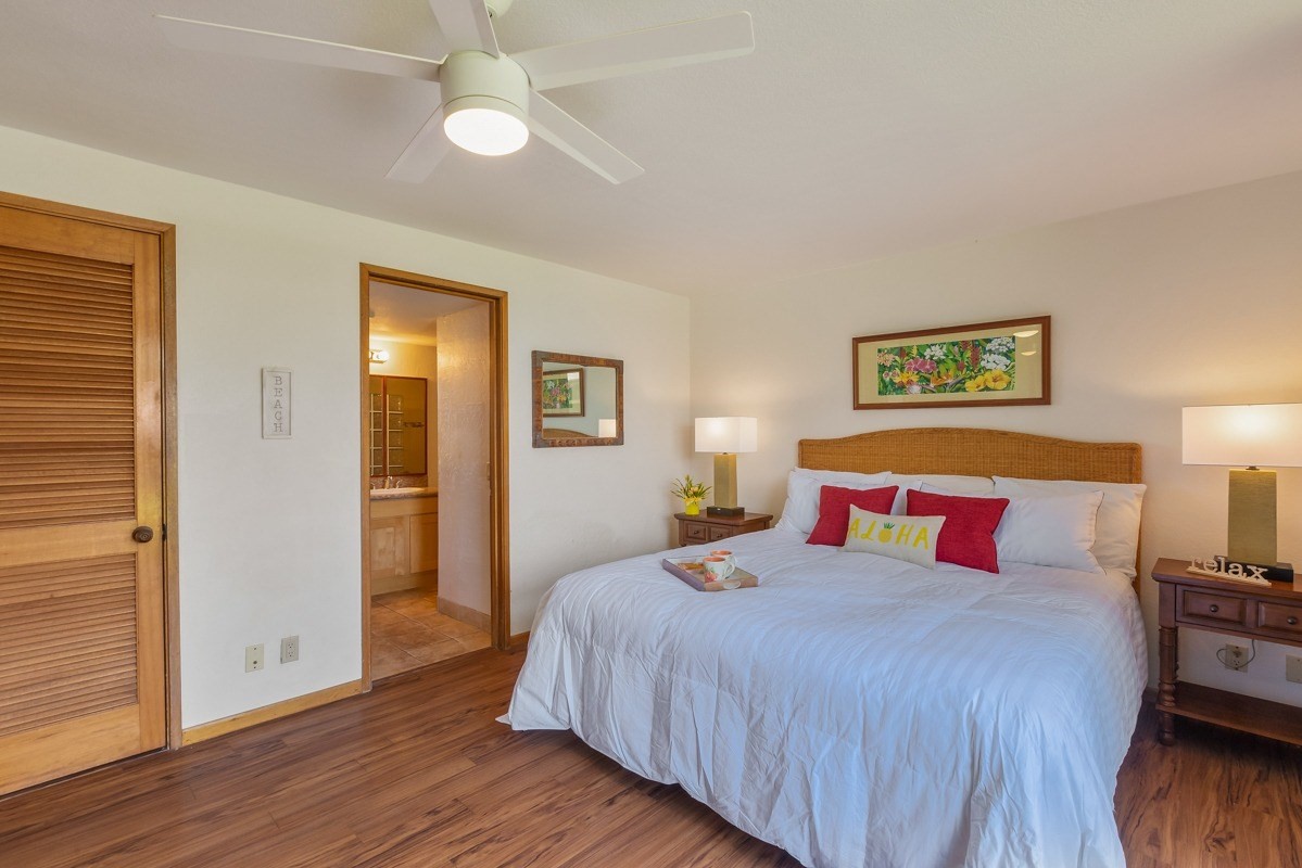 1661 Pee Road, Unit IIA101 Koloa, HI 96756 - Photo 15 of 28 a bedroom with a bed and wooden floor