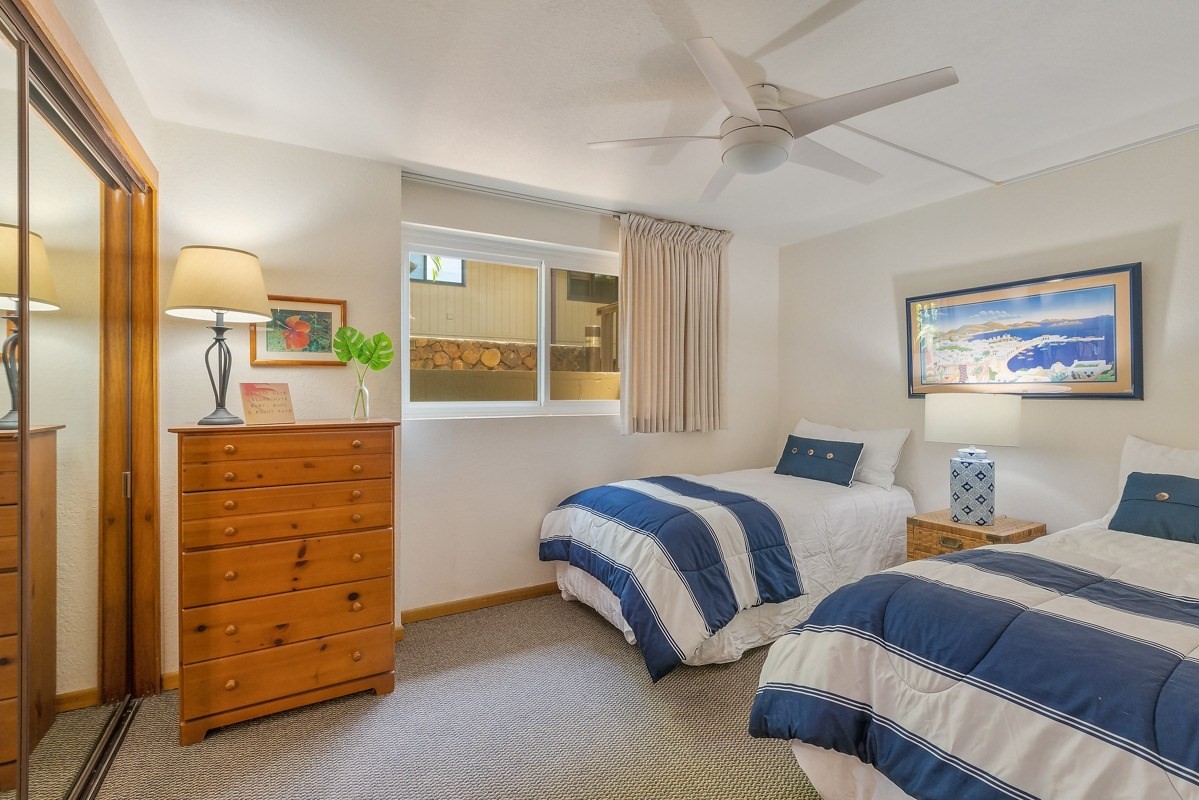 1661 Pee Road, Unit IIA101 Koloa, HI 96756 - Photo 18 of 28 a bedroom with two bed and a dresser