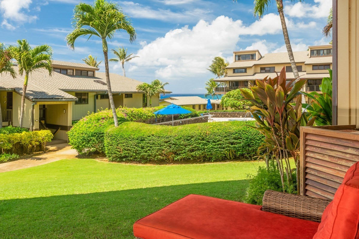 1661 Pee Road, Unit IIA101 Koloa, HI 96756 - Photo 23 of 28 a view of a garden with a building in the background