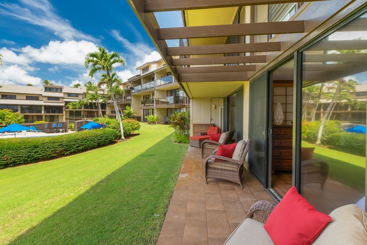1661 Pee Road, Unit IIA101 Koloa, HI 96756 - Photo 24 of 28 a view of swimming pool with a patio and garden