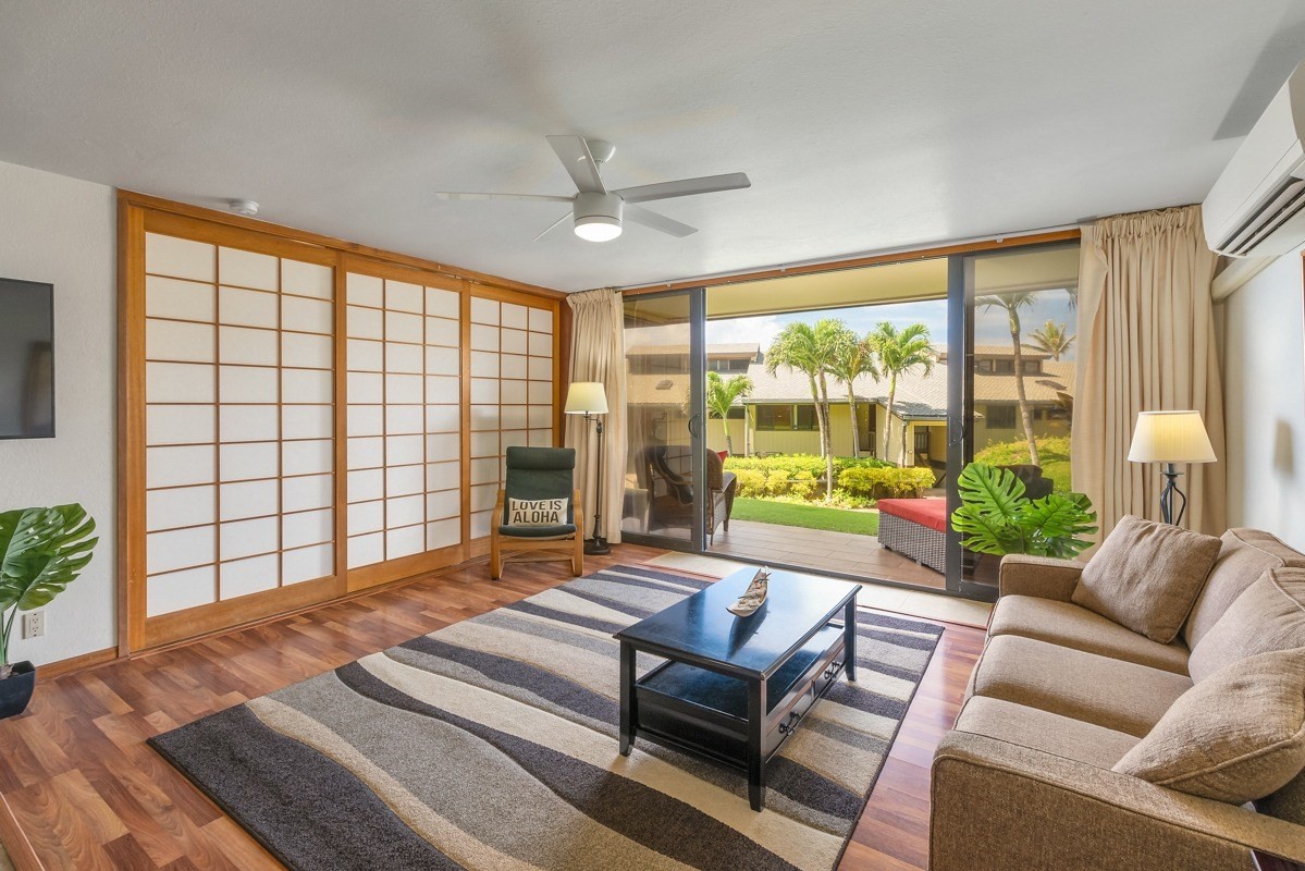 1661 Pee Road, Unit IIA101 Koloa, HI 96756 - Photo 5 of 28 a living room with furniture and a floor to ceiling window