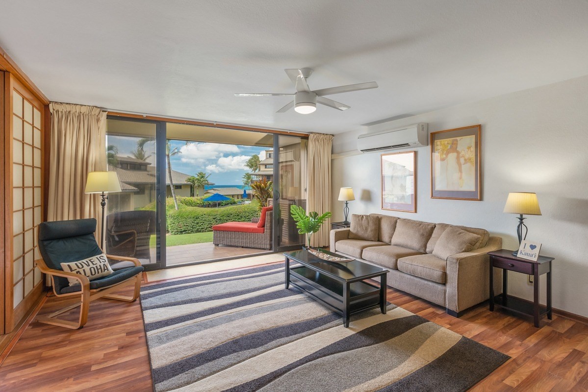 1661 Pee Road, Unit IIA101 Koloa, HI 96756 - Photo 6 of 28 a living room with furniture and a floor to ceiling window