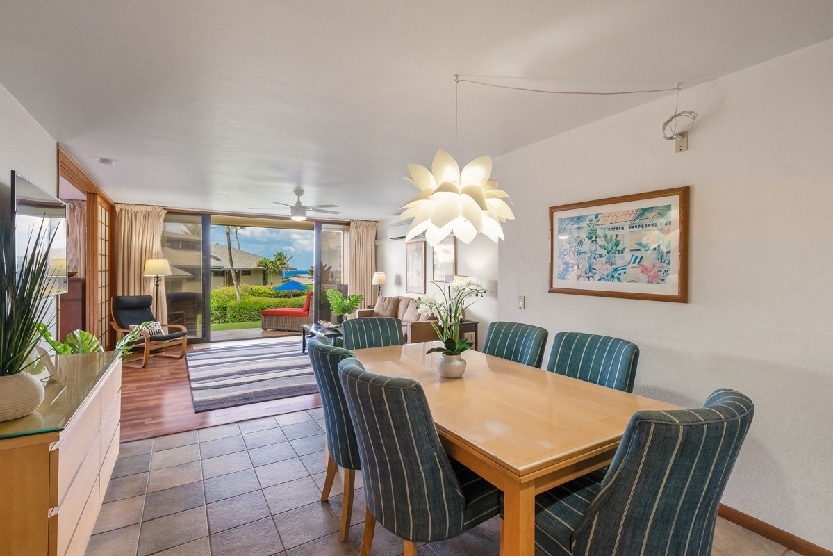 1661 Pee Road, Unit IIA101 Koloa, HI 96756 - Photo 8 of 28 a view of a dining room with furniture a livingroom and chandelier