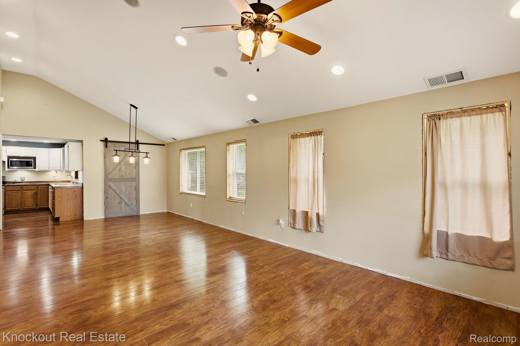 8811 Van Cleve Road Vassar, MI 48768 - Photo 7 of 39 Vaulted ceiling with recessed lighting and a ceiling fan, wood-finish flooring, and multiple windows