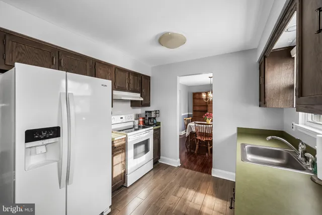 a kitchen with stainless steel appliances a refrigerator sink and stove
