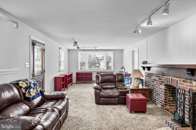 a living room with furniture a rug and a window