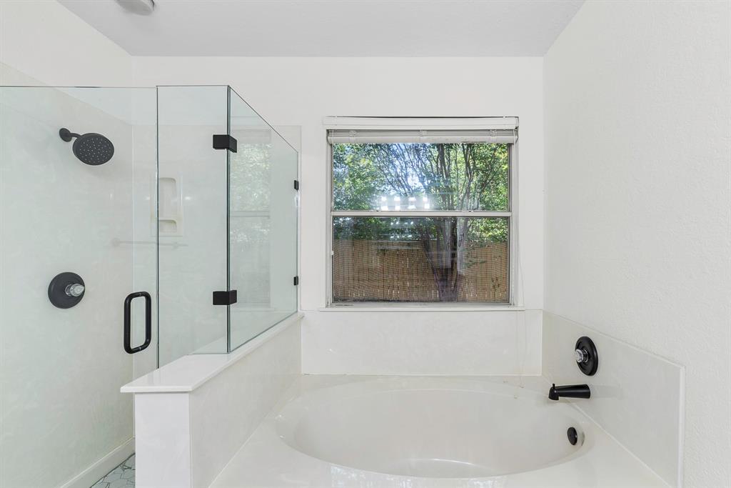 617 Barbara Way Bastrop, TX 78602 - Photo 10 of 20 Indulge in a tranquil bathing experience with this spacious soaking tub and adjacent walk-in shower.