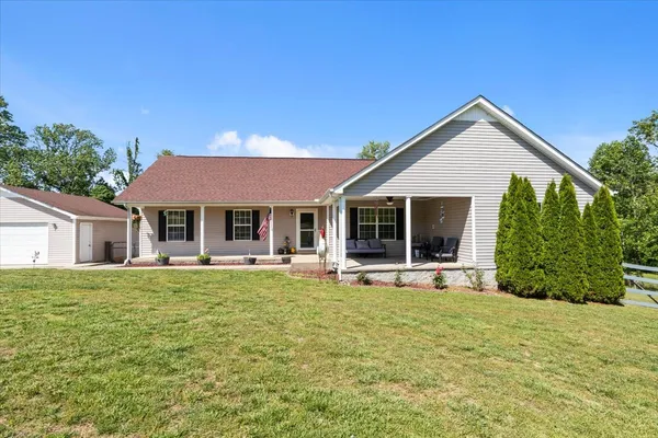 a front view of a house with a yard and porch