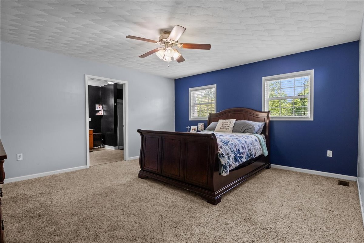 109 Bessie Clark Road Erin, TN 37061 - Photo 18 of 43 a bedroom with a bed and a chandelier