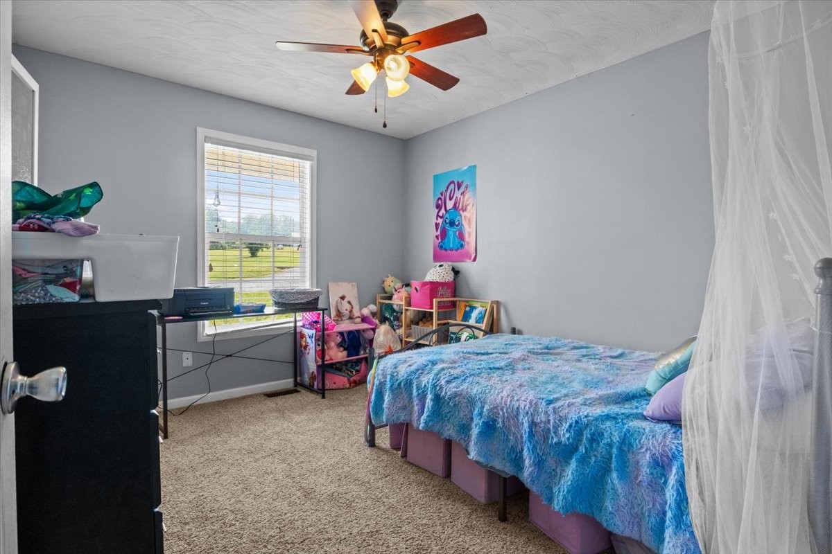 109 Bessie Clark Road Erin, TN 37061 - Photo 26 of 43 a bedroom with a bed and a desk