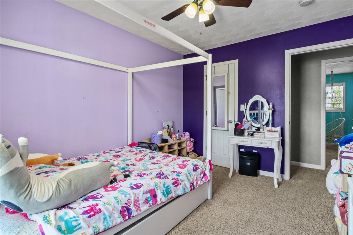 109 Bessie Clark Road Erin, TN 37061 - Photo 32 of 43 a bedroom with a bed and a chandelier